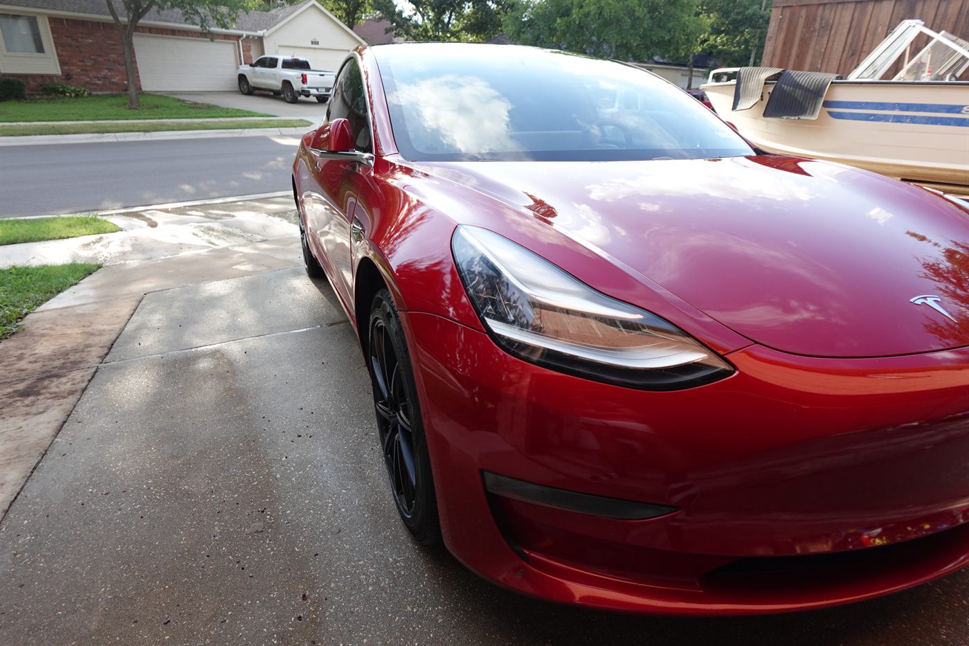 Red Tesla Model 3 after an exterior wash and wax